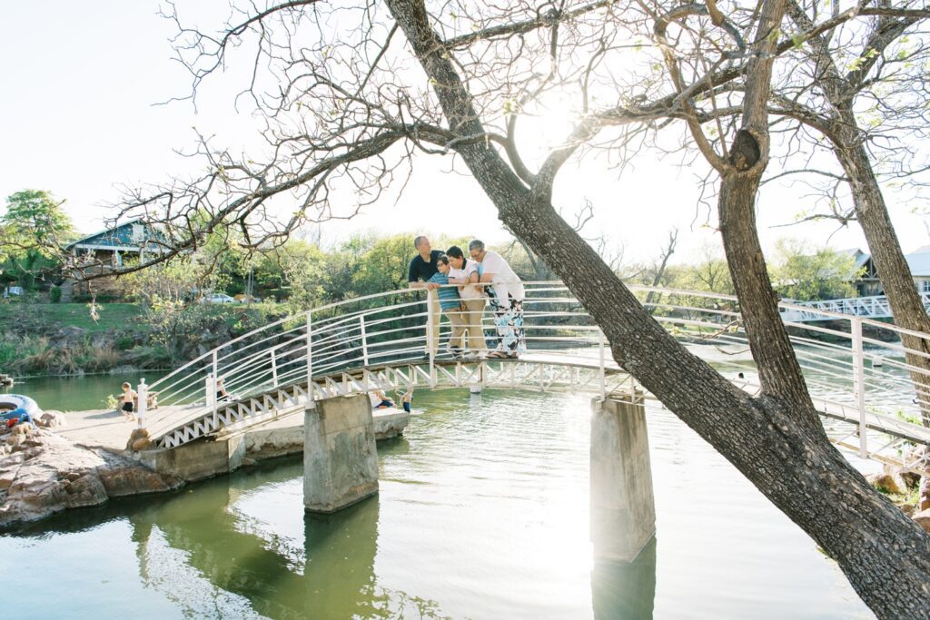 family smiling on bridge at medicine park oklahoma