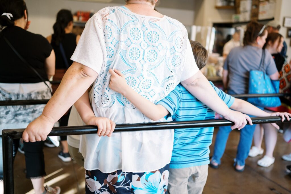 boys draping arms lovingly around mother