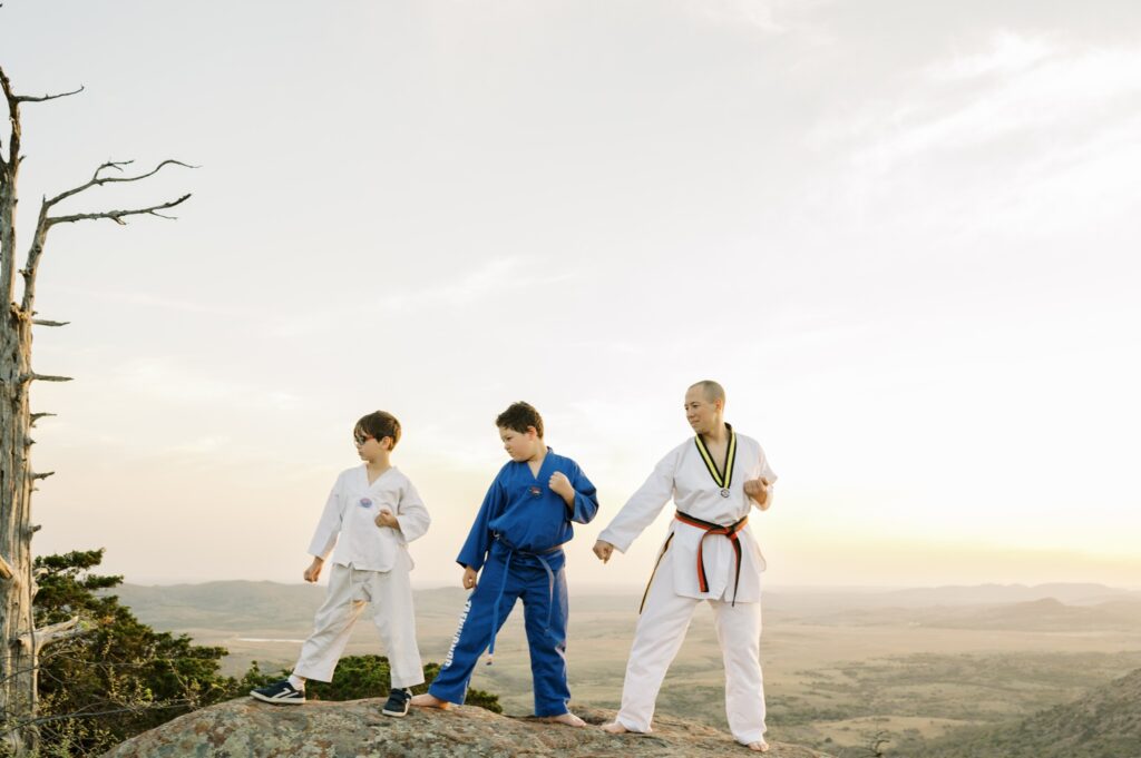 family doing taekwondo on top of mount scott oklahoma